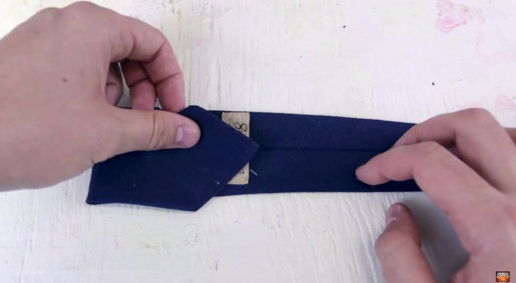 He starts by folding a tie ... the end result will give you a touch of STYLE!