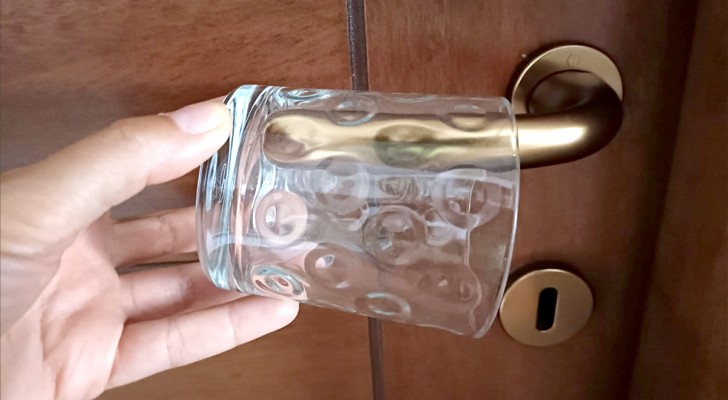 Many people put a glass on their hotel room's door handle while on vacation: why?