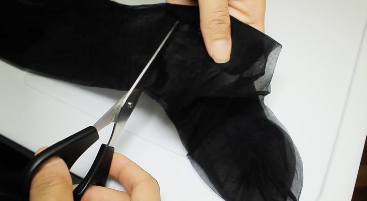 She starts by cutting an old pair of tights, what she's about to create is amazing!