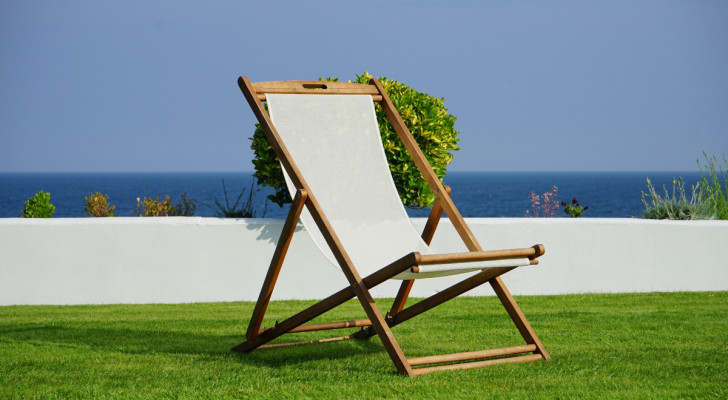 A canvas deckchair in a sunny garden