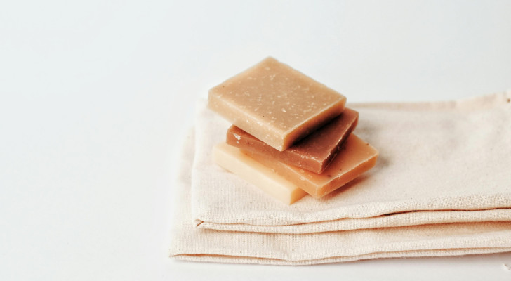 bars of handmade soap stacked on top of cotton towels