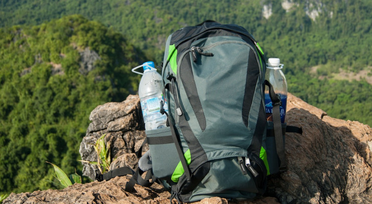 a backpack laying on rocks at a scenic spot