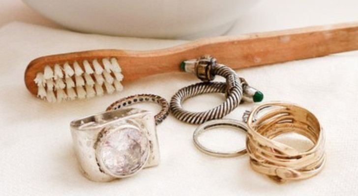 Jewelry placed on a shelf next to a toothbrush