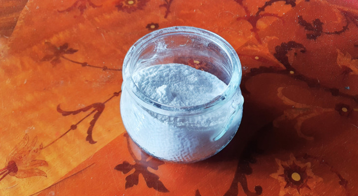 A jar of baking soda on a wooden table