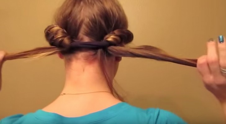 She rolls up her hair in a band, when she takes it off effect is surprising