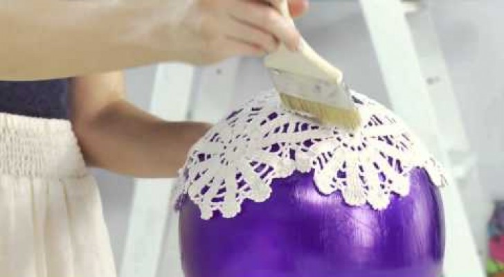 She puts doilies on a balloon and creates a crazy piece of furniture !