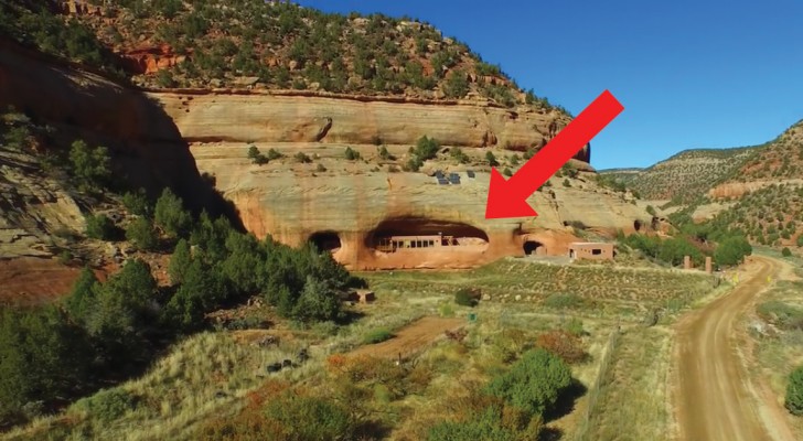 An elderly couple buys land and builds a house inside the base of a mountain